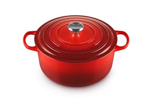 Le Creuset Signature 7-quart round Dutch oven in cerise with cream interior and brass knob.